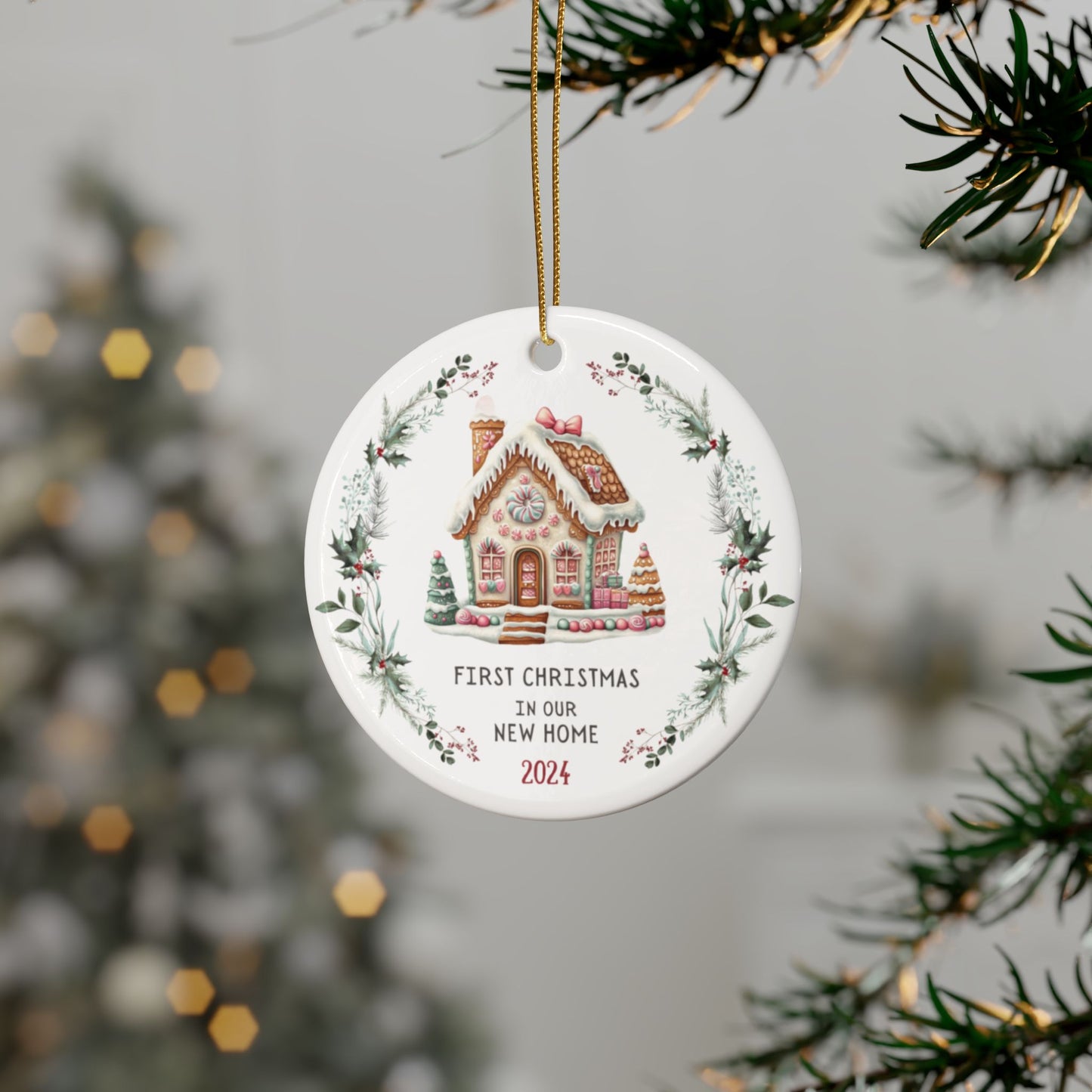 First christmas in our new home 2024 ceramic ornament gift with gingerbread house and wreath design - shown hanging on a tree - gift for someone who has recently moved into a new home